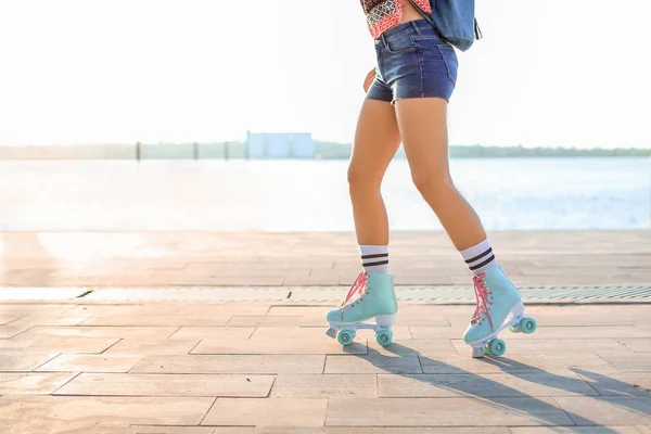 Beautiful young woman on roller skates outdoors — Stock Photo, Image