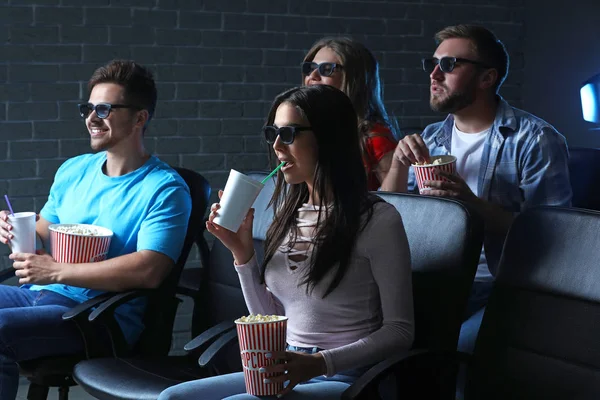 Friends with popcorn watching movie in cinema — Stock Photo, Image