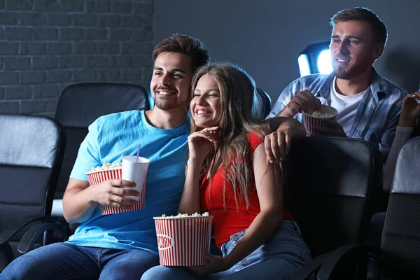 Friends with popcorn watching movie in cinema — Stock Photo, Image