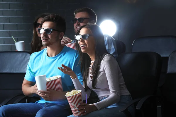 Friends with popcorn watching movie in cinema — Stock Photo, Image