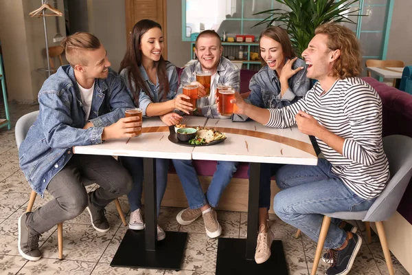 Friends drinking fresh beer in pub — Stock Photo, Image