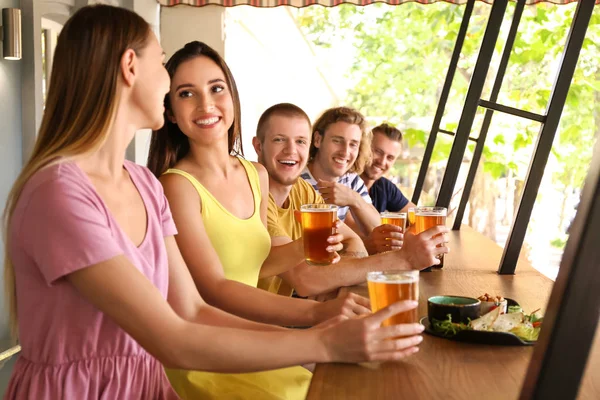 Friends drinking fresh beer in pub — Stock Photo, Image