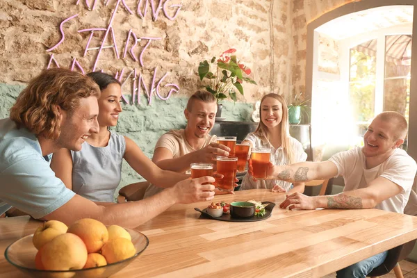 Friends drinking fresh beer in pub — Stock Photo, Image