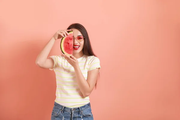 Beautiful young woman with slice of fresh watermelon on color background — Stock Photo, Image