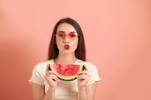 Gyönyörű fiatal nő, szelet friss görögdinnye a színes háttér — Stock Fotó