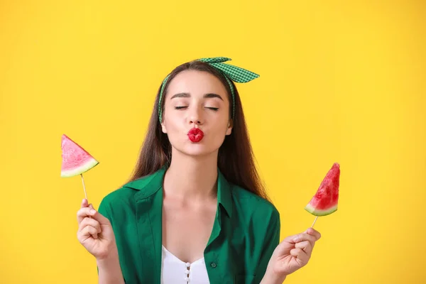 Beautiful young woman with slices of fresh watermelon on color background — Stock Photo, Image