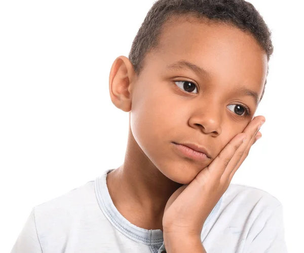 Little African-American boy suffering from toothache against white background — Stock Photo, Image