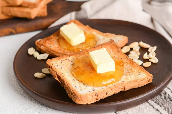 Tasty toasted bread, butter and jam on plate — Stock Photo, Image