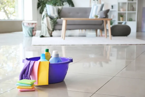 Set of cleaning supplies on floor in room — Stock Photo, Image