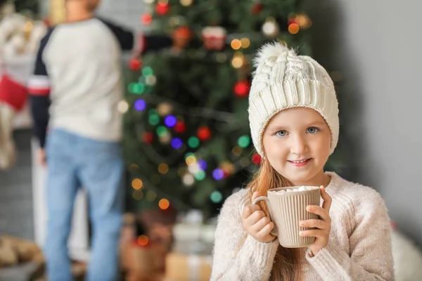 Cute little girl drinking hot chocolate at home on Christmas eve — Stock Photo, Image