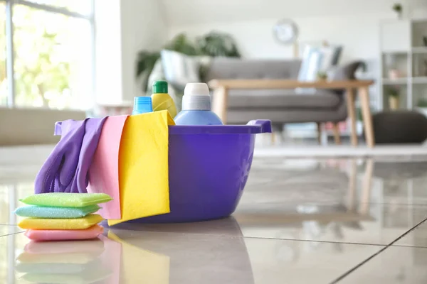 Set of cleaning supplies on floor in room — Stock Photo, Image