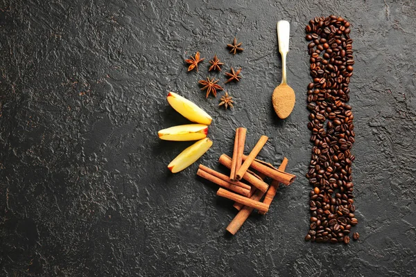 Aromatic cinnamon with coffee beans, anise and apple slices on dark background — Stock Photo, Image