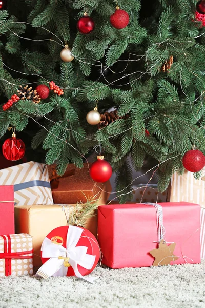 Many beautiful gift boxes under Christmas tree — Stock Photo, Image