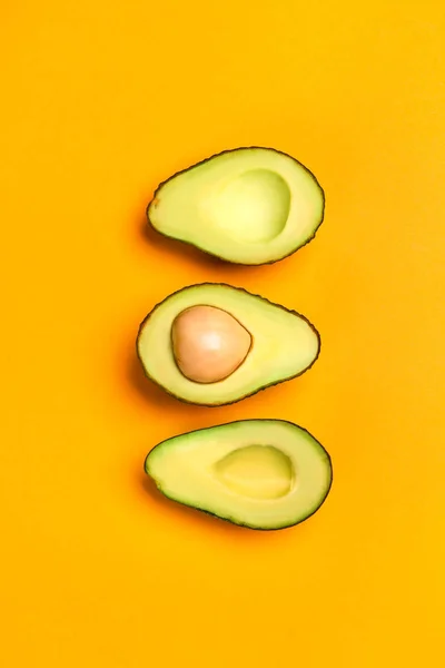 Helften van rijpe avocado op kleur achtergrond — Stockfoto