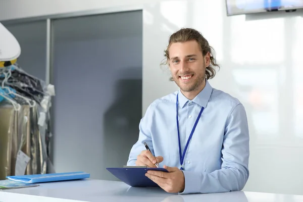 Worker of modern dry-cleaner\'s at reception