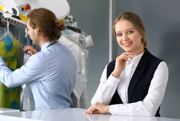 Workers of modern dry-cleaner's at reception — Stock Photo, Image