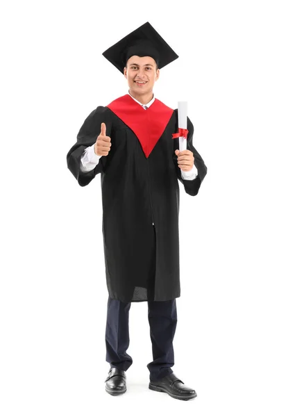 Jonge mannelijke student in Bachelor gewaad tonen duim-up op witte achtergrond — Stockfoto