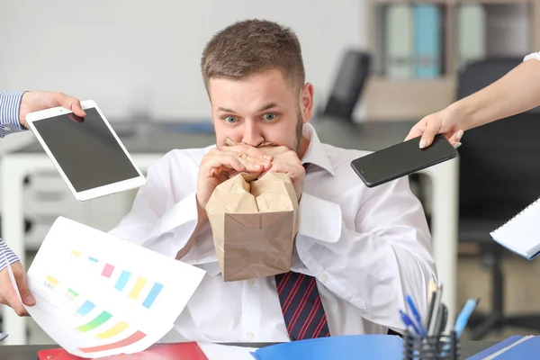 Overworked businessman having panic attack in office