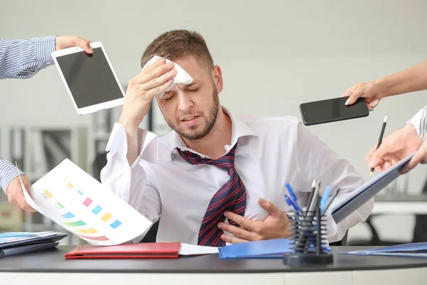 Overworked businessman having panic attack in office