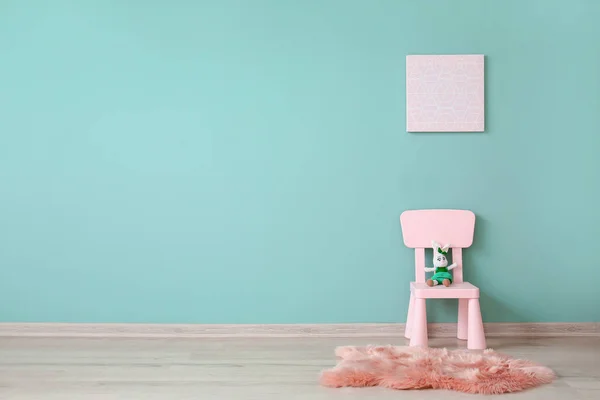 Chair with toy near color wall in children's room — Stock Photo, Image