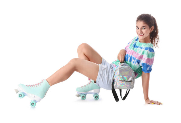 Teenage girl on roller skates against white background