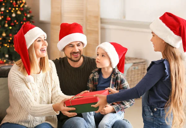 Little girl giving her mother Christmas gift at home — Stock Photo, Image