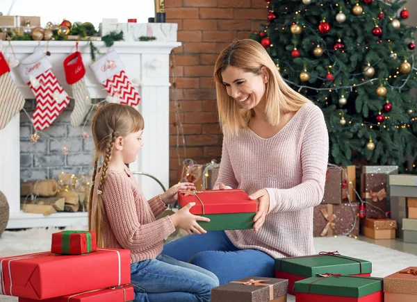 Menina bonito e sua mãe com presentes de Natal em casa — Fotografia de Stock