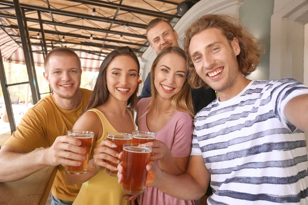 Friends taking selfie while drinking fresh beer in pub — Stock Photo, Image