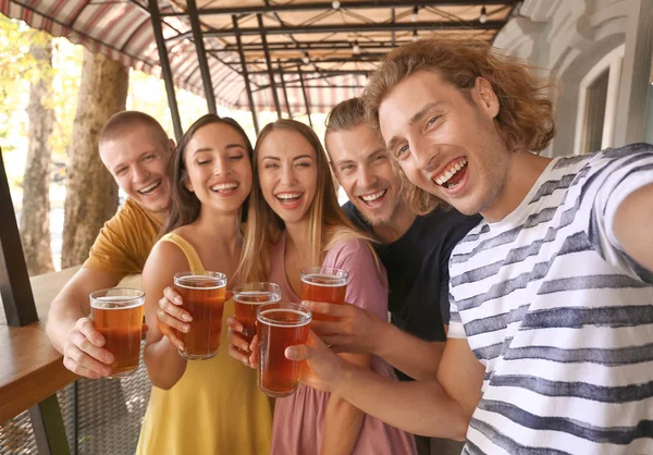 Friends taking selfie while drinking fresh beer in pub — Stock Photo, Image