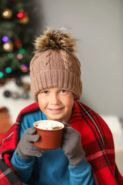 Cute little boy drinking hot chocolate at home on Christmas eve — Stock Photo, Image