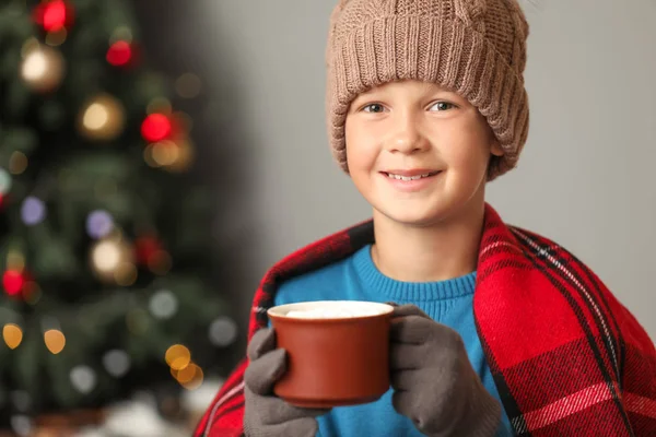 Cute little boy drinking hot chocolate at home on Christmas eve — Stock Photo, Image