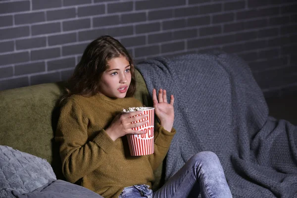 Emotional teenage girl watching TV at night — Stock Photo, Image