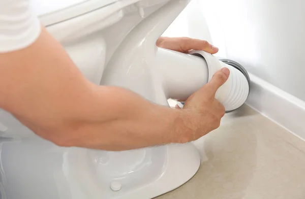 Plumber installing toilet in restroom, closeup — Stock Photo, Image