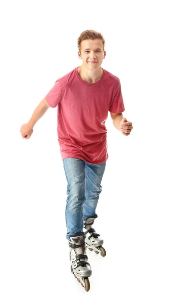 Adolescente ragazzo su pattini a rotelle contro sfondo bianco — Foto Stock