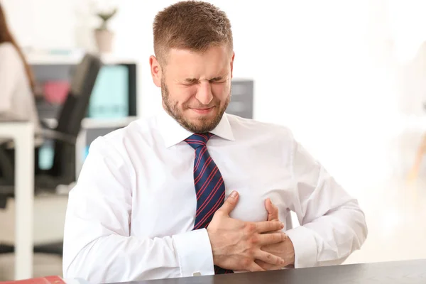 Businessman having panic attack in office