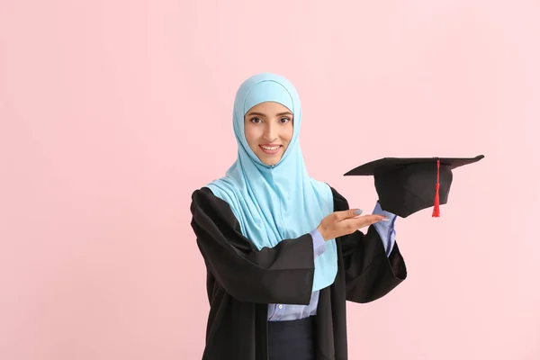 Muslim female graduate on color background — Stock Photo, Image