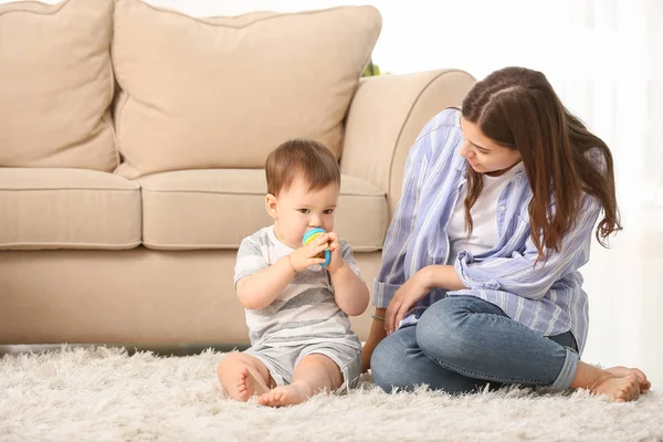 Mother and her little son with nibbler at home — Stock Photo, Image