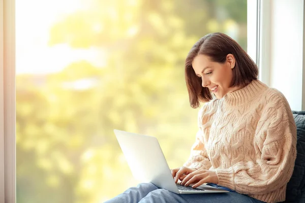 Morning of beautiful young woman with laptop near window — Stock Photo, Image