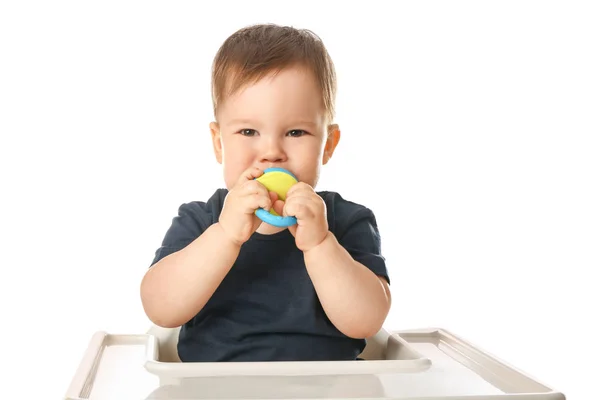 Cute little boy with nibbler sitting in high chair against white background — Stock Photo, Image