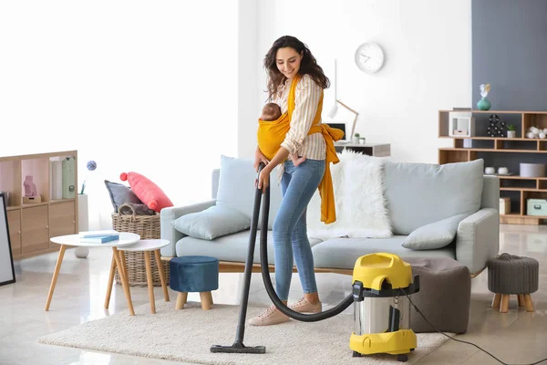 Young mother with little baby doing chores at home — Stock Photo, Image