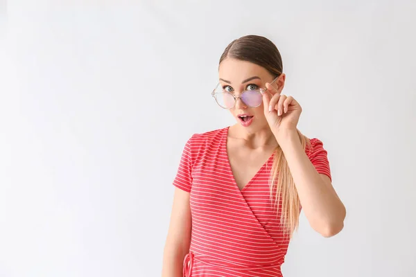 Surprised young woman on white background — Stock Photo, Image