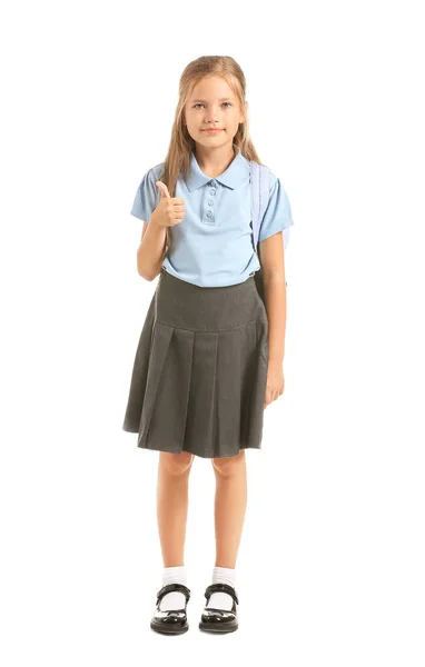 Kleine Schülerin zeigt Daumen nach oben auf weißem Hintergrund — Stockfoto