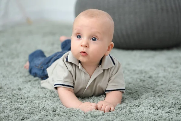 Adorable little baby crawling on soft carpet — Stock Photo, Image