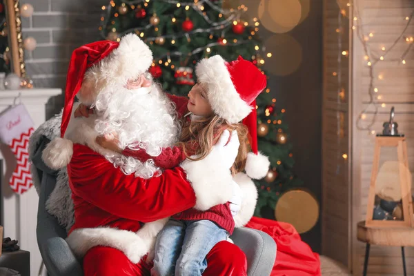 Santa Claus and little girl in room decorated for Christmas — Stock Photo, Image