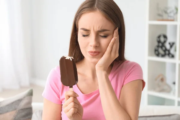 Young woman with sensitive teeth and cold ice-cream at home — Stock Photo, Image