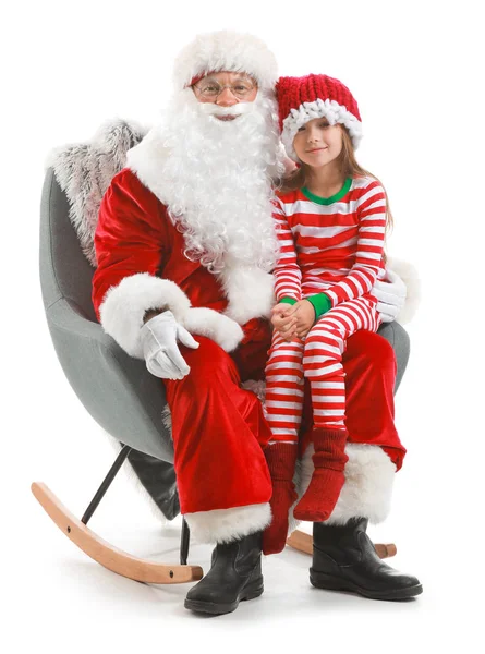 Santa Claus and little girl sitting in armchair against white background — Stock Photo, Image