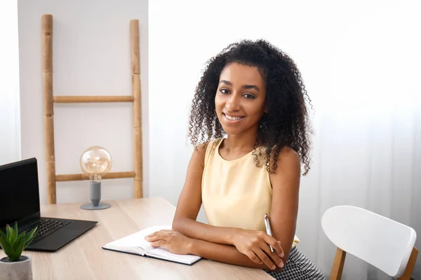 Portrait of beautiful African-American businesswoman working in office — Stock Photo, Image