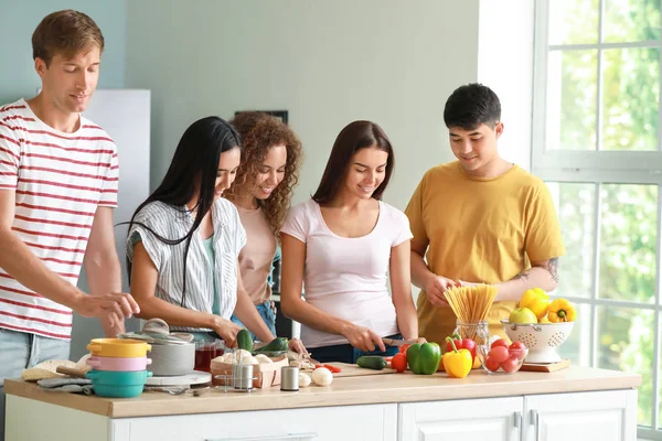 Glückliche Freunde kochen gemeinsam in der Küche — Stockfoto