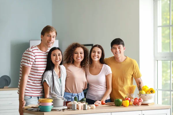 Glückliche Freunde kochen gemeinsam in der Küche — Stockfoto