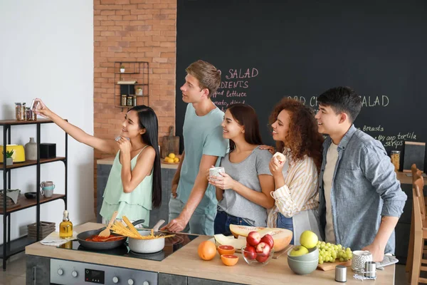 Amigos felizes tomando selfie enquanto cozinham juntos na cozinha — Fotografia de Stock